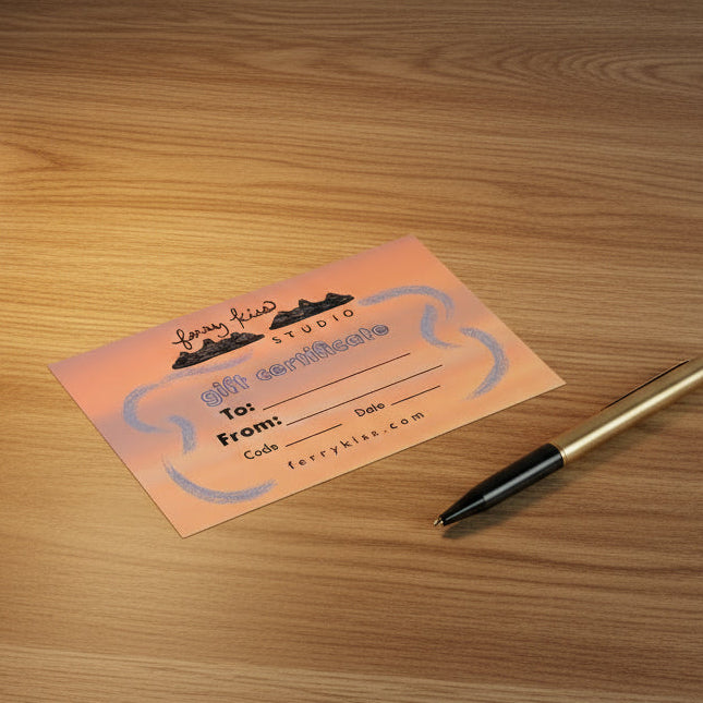 Pink gift certificate on a wooden surface with a pen and lamp in the background